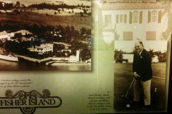 A display featuring historic photos of Fisher Island, including a black and white image of Carl Fisher playing golf and an aerial view of the island. The text emphasizes the Vanderbilt estate, underscoring its significance in luxury real estate branding.