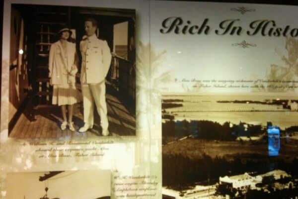 A historical display titled "Rich In History" featuring vintage photographs of a couple, an aerial view of the island, and text detailing the island's significance, seamlessly blending luxury real estate branding to highlight its timeless charm.