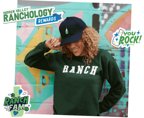 A woman with curly hair adjusts her black cap, wearing a green "RANCH" sweatshirt. The background features colorful graffiti and text promoting "Hidden Valley Ranchology Rewards," blending art and User Experience Design to captivate viewers.